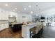 Open-concept kitchen with a large island, granite countertops, stainless steel appliances, and a seamless flow to the living room at 2005 Westbourne Way, Alpharetta, GA 30022