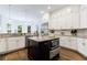 Modern kitchen boasts granite countertops, an island with stainless steel appliances, and ample cabinet space at 2005 Westbourne Way, Alpharetta, GA 30022