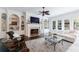 Living room with fireplace, built-in shelves, dark wood floors, ceiling fan and view to the pool at 2005 Westbourne Way, Alpharetta, GA 30022