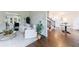 Spacious living room features hardwood floors, white armchairs, area rug and a view of the staircase at 2005 Westbourne Way, Alpharetta, GA 30022