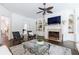 Living room with fireplace, built-in shelves, dark wood floors, ceiling fan and glass coffee table at 2005 Westbourne Way, Alpharetta, GA 30022