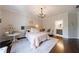 A sunlit main bedroom featuring a decorative chandelier, ensuite bathroom at 2005 Westbourne Way, Alpharetta, GA 30022