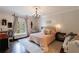 A sunlit main bedroom featuring a decorative chandelier and a balcony at 2005 Westbourne Way, Alpharetta, GA 30022