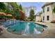 Beautiful in-ground pool with a stone deck, waterfall feature, and lush landscaping at 2005 Westbourne Way, Alpharetta, GA 30022