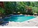 Inviting in-ground pool with waterfall feature, complemented by surrounding lush greenery at 2005 Westbourne Way, Alpharetta, GA 30022