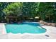 A pristine in-ground swimming pool framed by lush landscaping and a shaded pergola at 2005 Westbourne Way, Alpharetta, GA 30022