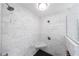 This luxurious shower features marble tile, black tile base, and multiple shower heads for a spa-like experience at 2005 Westbourne Way, Alpharetta, GA 30022