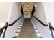 Elegant staircase featuring plush patterned carpet, dark wood railing, and decorative lighting at 2005 Westbourne Way, Alpharetta, GA 30022