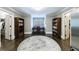 Study with hardwood floors, dark wood bookshelves, desk with rounded windows, and doors to closets at 2005 Westbourne Way, Alpharetta, GA 30022