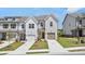 Modern townhome exteriors with crisp white facades, tidy landscaping, and private driveways at 257 Kenoot Dr # 42, Mcdonough, GA 30253