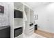 Functional closet space with open shelving, storage baskets, and a built-in desk at 3120 Godby Rd # 1118, Atlanta, GA 30349