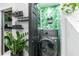 Convenient laundry room with modern appliances and stylish botanical-themed wallpaper at 3120 Godby Rd # 1118, Atlanta, GA 30349