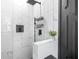 Modern shower featuring stylish white tile and sleek, matte black fixtures and trim at 3120 Godby Rd # 1118, Atlanta, GA 30349