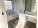 Inviting bathroom with a soaking tub and vanity with storage at 4578 Carriage Park Dr, Lithonia, GA 30038