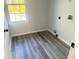 Efficient laundry room with sleek wood-look flooring and a window for natural light at 4578 Carriage Park Dr, Lithonia, GA 30038