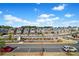 Aerial view of a neighborhood with townhomes, a community garden, and parking at 561 S Club Dr, Woodstock, GA 30188