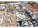 Stunning aerial view of a community featuring a sparkling pool, clubhouse, and well-maintained common areas at 561 S Club Dr, Woodstock, GA 30188