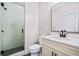 Modern bathroom featuring a walk-in shower, vanity, toilet, and stylish mirror at 561 S Club Dr, Woodstock, GA 30188