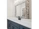Bathroom vanity with white countertop, blue cabinets, decorative mirror and black faucet at 561 S Club Dr, Woodstock, GA 30188