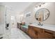 Well-lit bathroom features double vanity, quartz countertops and built-in bench at 561 S Club Dr, Woodstock, GA 30188