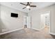 Bedroom with carpet, a ceiling fan, neutral walls, and doorways to other rooms at 561 S Club Dr, Woodstock, GA 30188