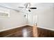 Spacious room with hardwood floors, a ceiling fan, and a view into the bathroom at 561 S Club Dr, Woodstock, GA 30188