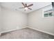 Well-lit bedroom with neutral walls, a ceiling fan, and a window to the outside at 561 S Club Dr, Woodstock, GA 30188