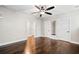 Large bedroom with hardwood floors, multiple closets, and doorways at 561 S Club Dr, Woodstock, GA 30188