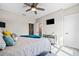 Cozy bedroom featuring a ceiling fan, mounted TV, bedside table, and neutral walls at 561 S Club Dr, Woodstock, GA 30188