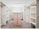 Bright walk-in closet with built-in shelving and carpet flooring at 561 S Club Dr, Woodstock, GA 30188