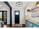 Bright entryway features hardwood floors, stylish decor, and a view to the living area, creating a welcoming entrance at 561 S Club Dr, Woodstock, GA 30188
