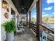 Spacious front porch with comfortable seating, stone flooring, ceiling fans, and neighborhood views, perfect for relaxing at 561 S Club Dr, Woodstock, GA 30188