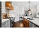 Modern kitchen showcasing stainless steel appliances, custom cabinets, and a unique range hood at 561 S Club Dr, Woodstock, GA 30188