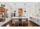 Stylish kitchen with a central island, modern pendant lighting, and stainless steel appliances at 561 S Club Dr, Woodstock, GA 30188