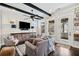 Comfortable living room with beamed ceilings, a decorative console, and access to a screened porch at 561 S Club Dr, Woodstock, GA 30188