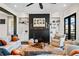Elegant living room with hardwood floors, a fireplace, built-in shelving, and comfortable seating for relaxation and entertaining at 561 S Club Dr, Woodstock, GA 30188