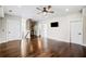 Open living room with hardwood flooring, bar area and a modern ceiling fan at 561 S Club Dr, Woodstock, GA 30188