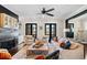 Inviting living room featuring a fireplace, ceiling fan, and access to the outdoors through French doors at 561 S Club Dr, Woodstock, GA 30188