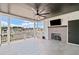 Covered patio with a fireplace, ceiling fan, and views of the neighborhood at 561 S Club Dr, Woodstock, GA 30188