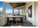 Entertaining outdoor patio with built-in grill, bar seating and neighborhood views at 561 S Club Dr, Woodstock, GA 30188