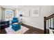 Cozy sitting room features plush seating, hardwood floors and natural light at 561 S Club Dr, Woodstock, GA 30188