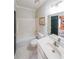 Clean bathroom with white tiled floor, tub/shower combination, and vanity with sink at 1201 Lake Washington Dr, Lawrenceville, GA 30043