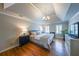 Comfortable bedroom with hardwood floors, tray ceiling, and lots of natural light at 1201 Lake Washington Dr, Lawrenceville, GA 30043