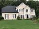 Elegant two-story home with manicured lawn, black shutters and decorative trim at 1201 Lake Washington Dr, Lawrenceville, GA 30043