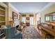 Elegant living room with fireplace, built-in bookshelves and a piano at 1201 Lake Washington Dr, Lawrenceville, GA 30043
