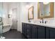 A bright bathroom features a modern double vanity and a soaking tub at 220 3Rd St, Fayetteville, GA 30214