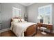 Cozy bedroom with gray walls, wood floors, and a comfy bed at 220 3Rd St, Fayetteville, GA 30214