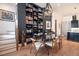 Elegant dining area showcases a large bookshelf, hardwood floors, and stylish decor near the kitchen at 220 3Rd St, Fayetteville, GA 30214