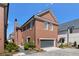 Brick exterior showcasing a garage and well maintained landscaping at 220 3Rd St, Fayetteville, GA 30214