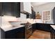 Gourmet kitchen with stainless steel appliances, quartz countertops, and wood floors at 220 3Rd St, Fayetteville, GA 30214